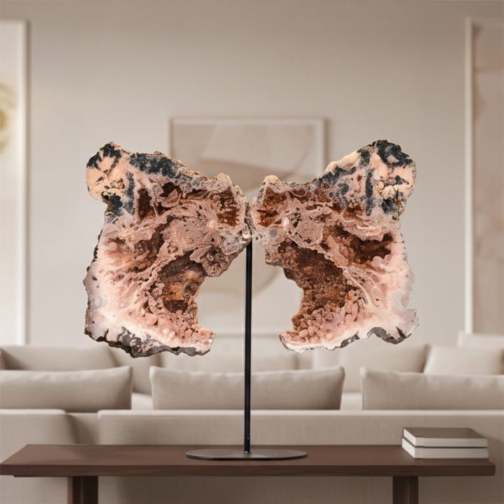 Natural Pink Amethyst wings on custom metal stand displayed in a modern living room interior