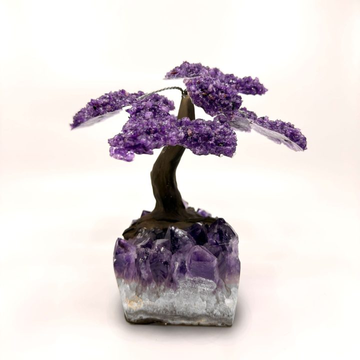 Handcrafted amethyst gemstone tree sculpture with full view on natural crystal base