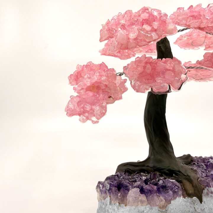 Rose quartz gemstone tree upper section displaying pink crystal clusters and dark trunk detail