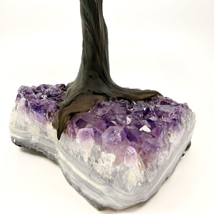 Amethyst crystal base of rose quartz gemstone tree showcasing natural purple crystal formation