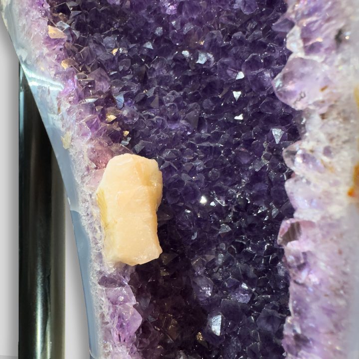 Peach Calcite crystal inside Amethyst geode