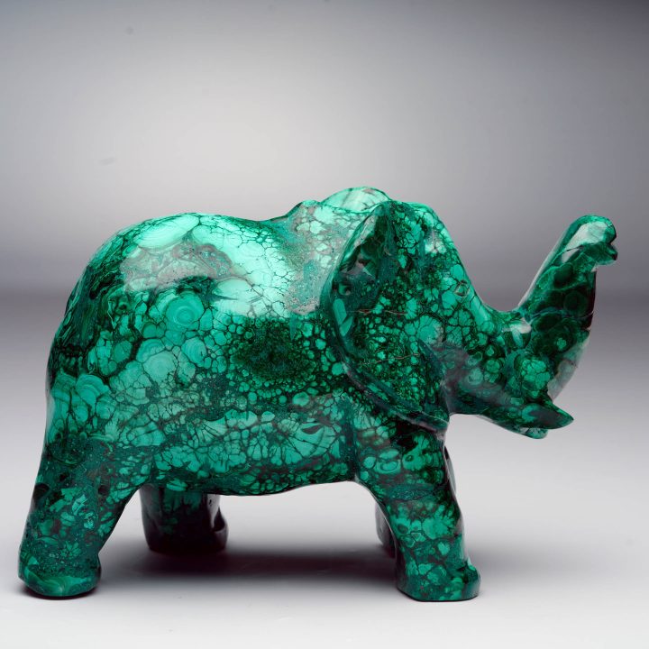 Malachite elephant carving with flowing banding and polished finish