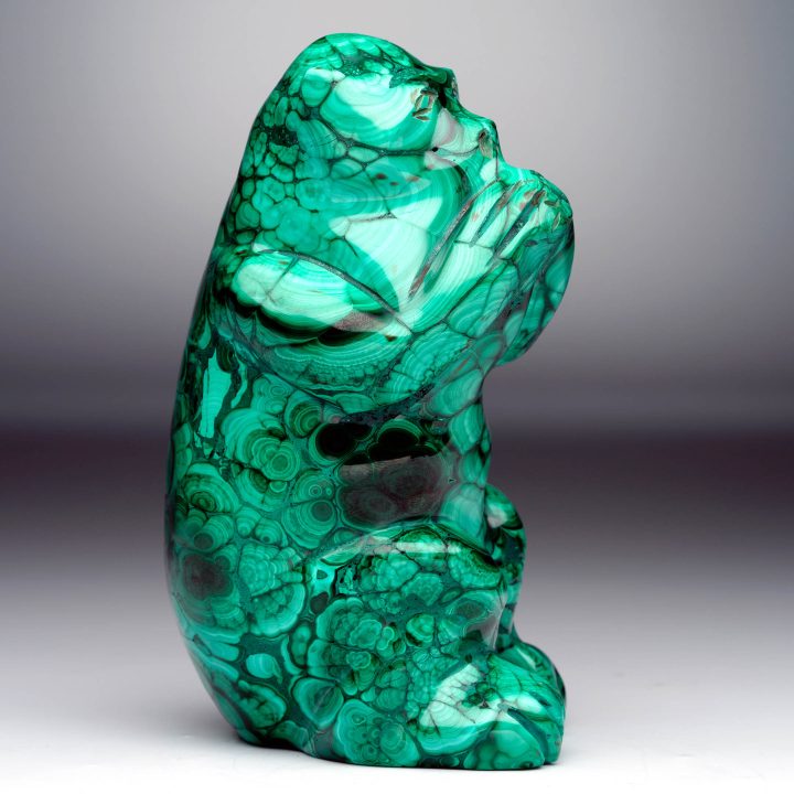 Hand-carved Malachite monkey sculpture showing polished green banding