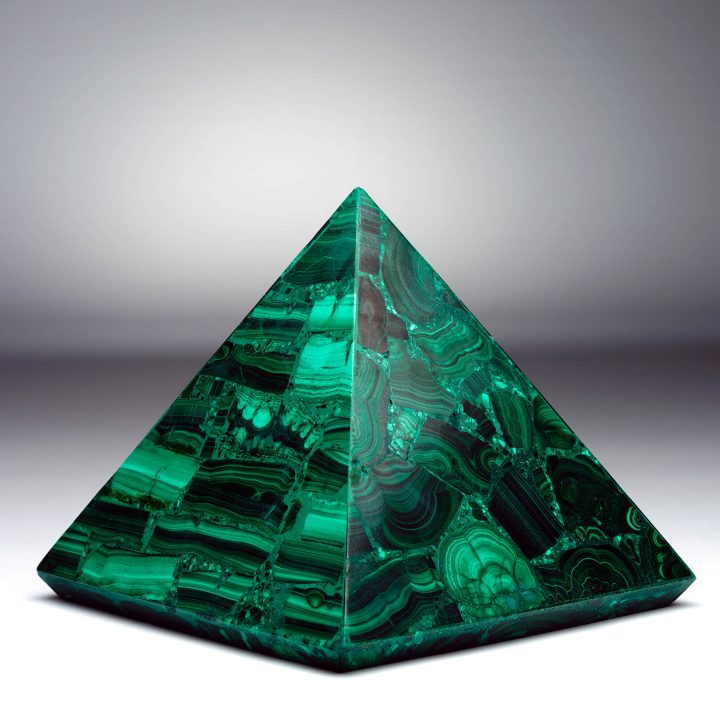 Malachite pyramid with striped green banding and polished symmetry