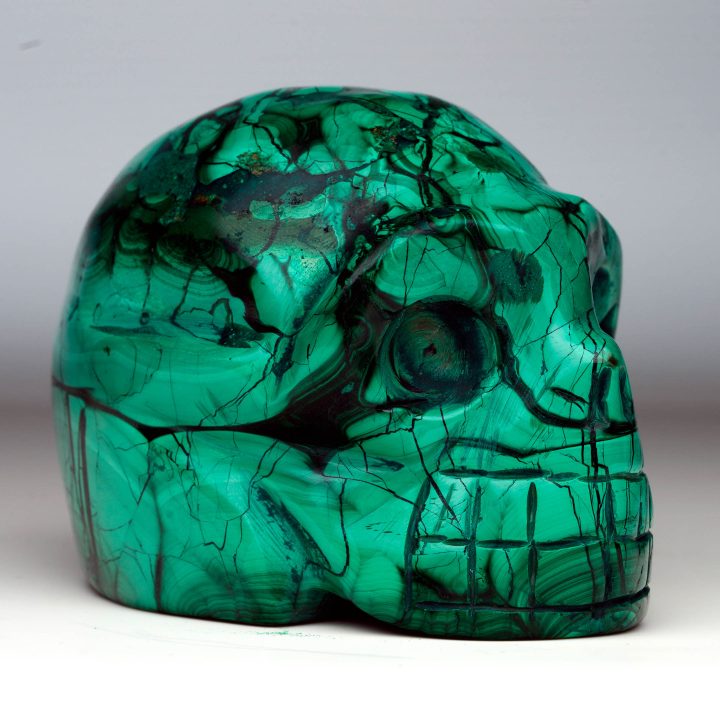 Polished Malachite skull with detailed carving