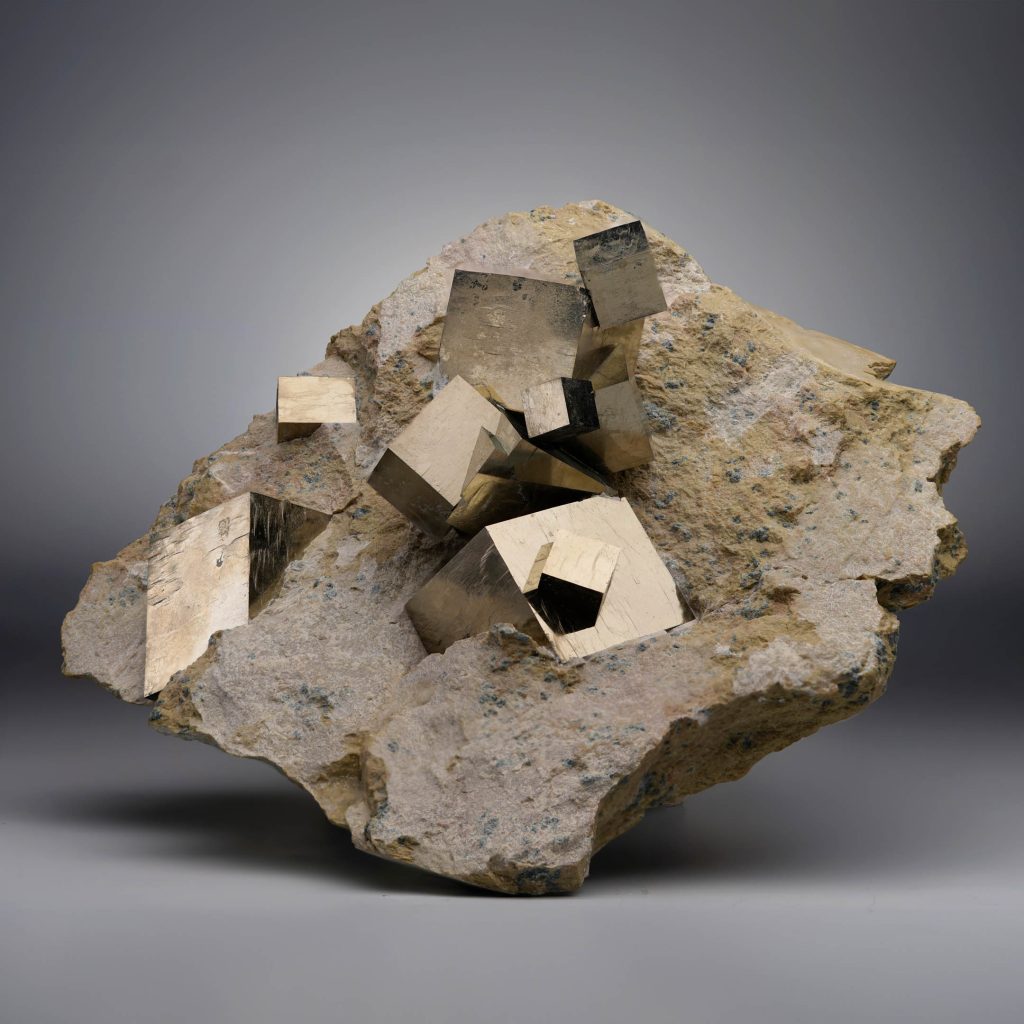 Spanish Pyrite specimen with golden cubic crystals on limestone matrix