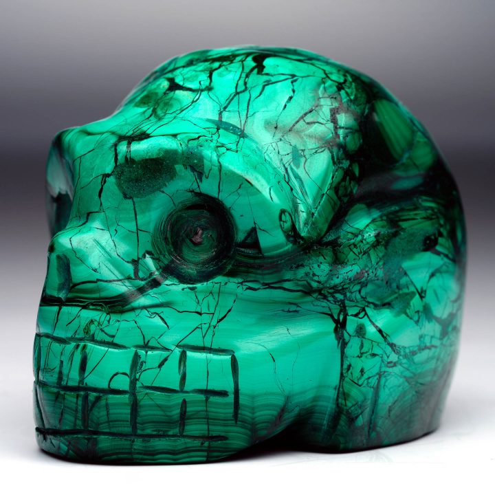 Hand-carved Malachite skull – angled side profile with veining