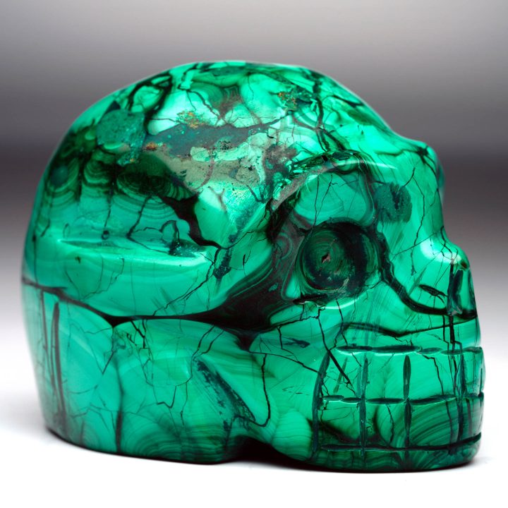 Hand-carved Malachite skull – side profile view