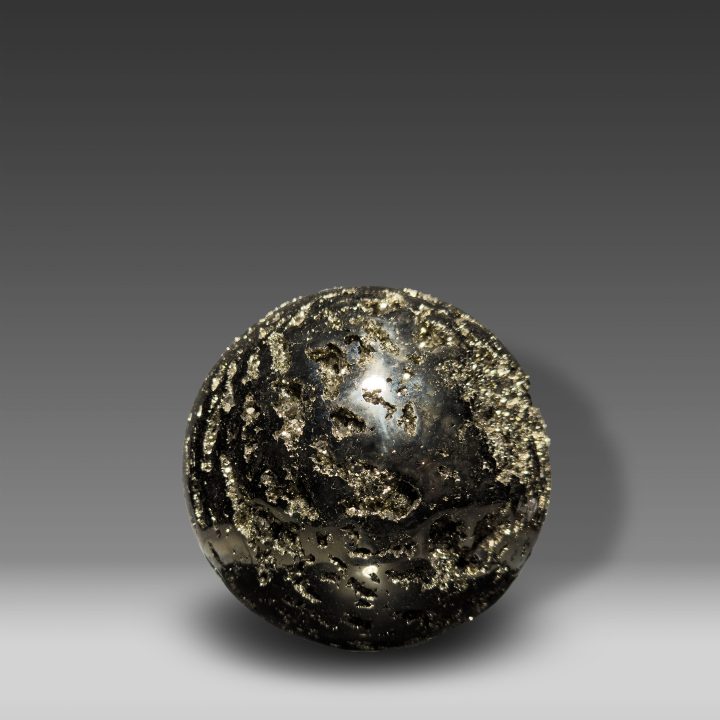 Hand-polished Pyrite sphere showing golden metallic crystal clusters.