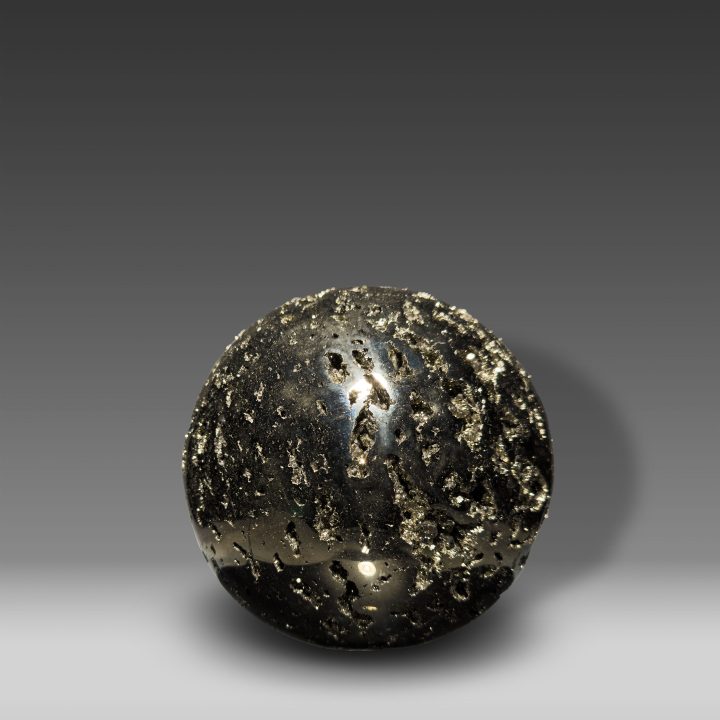 Large polished Pyrite sphere from Peru with golden metallic sheen.