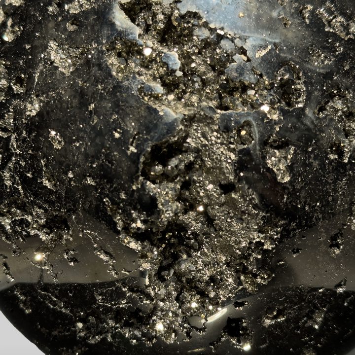 Large polished Pyrite sphere from Peru with radiant metallic luster.
