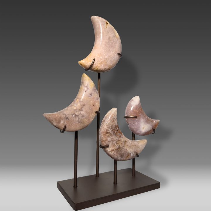 Side view of Pink Amethyst moon sculpture on stand