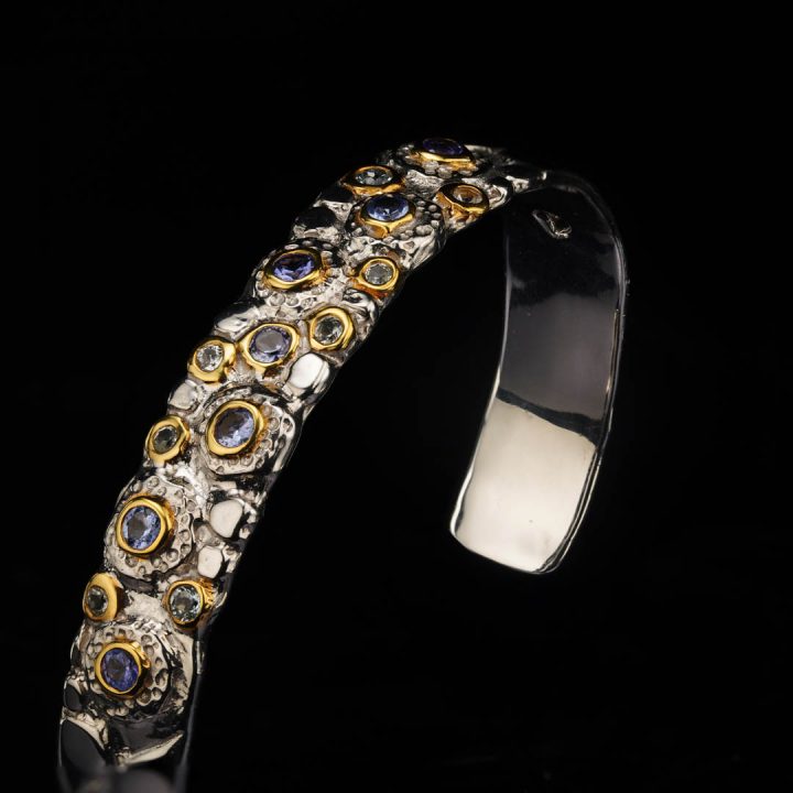 Silver and gold-accent bracelet set with Tanzanite and Blue Topaz gemstones