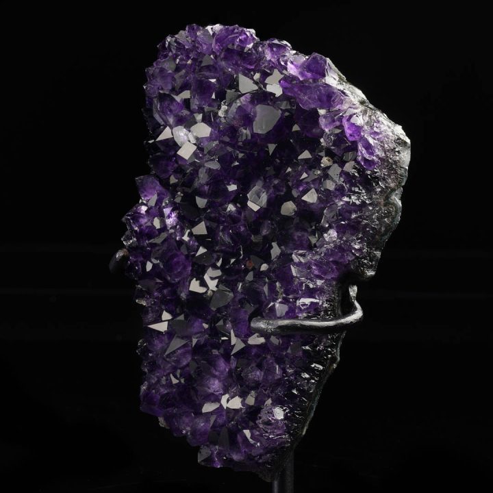 Decorative amethyst crystal geode on metal stand for luxury home decor