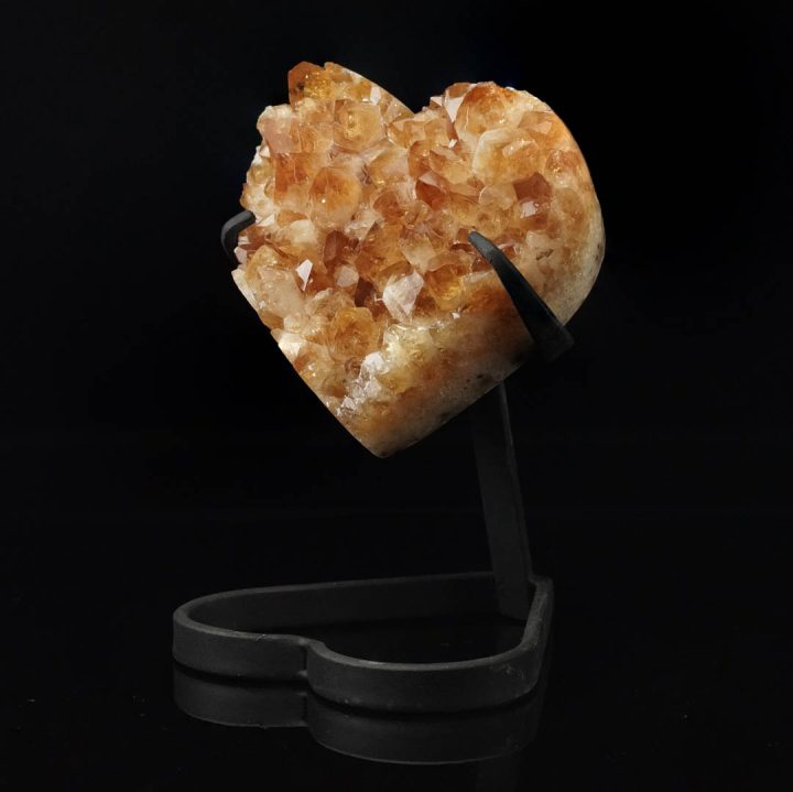 Golden citrine crystal heart sculpture on minimalist stand