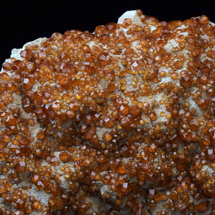 Collector spessartine garnet specimen on feldspar matrix