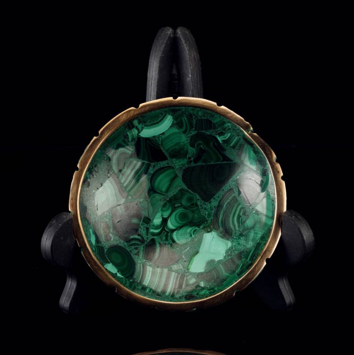 Decorative malachite bowl with gold edge on black background