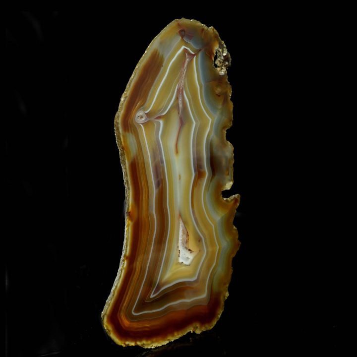 Agate slice in rich amber hues with unique flowing patterns