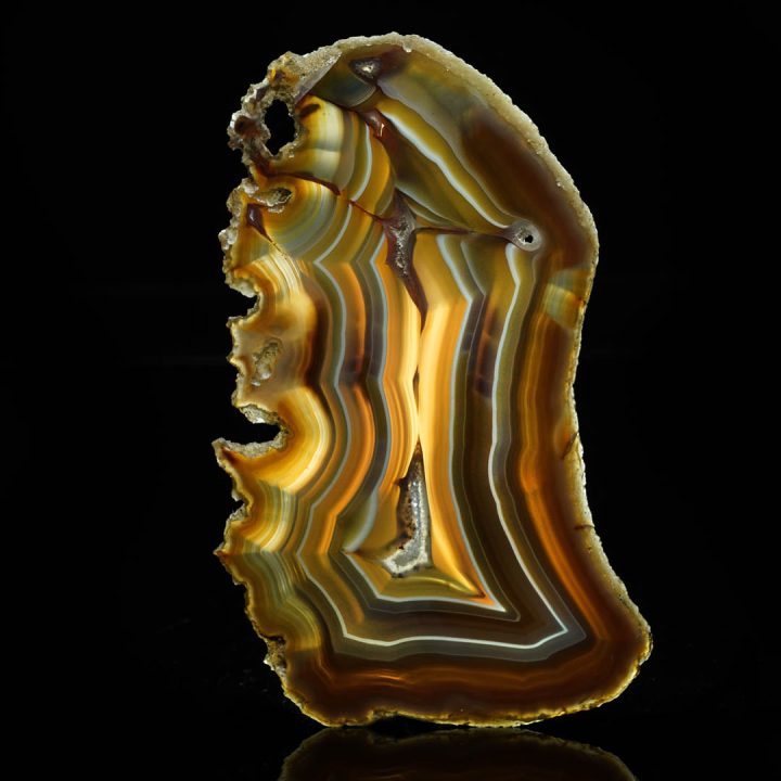 Agate slice with golden-orange bands and a semi-translucent core