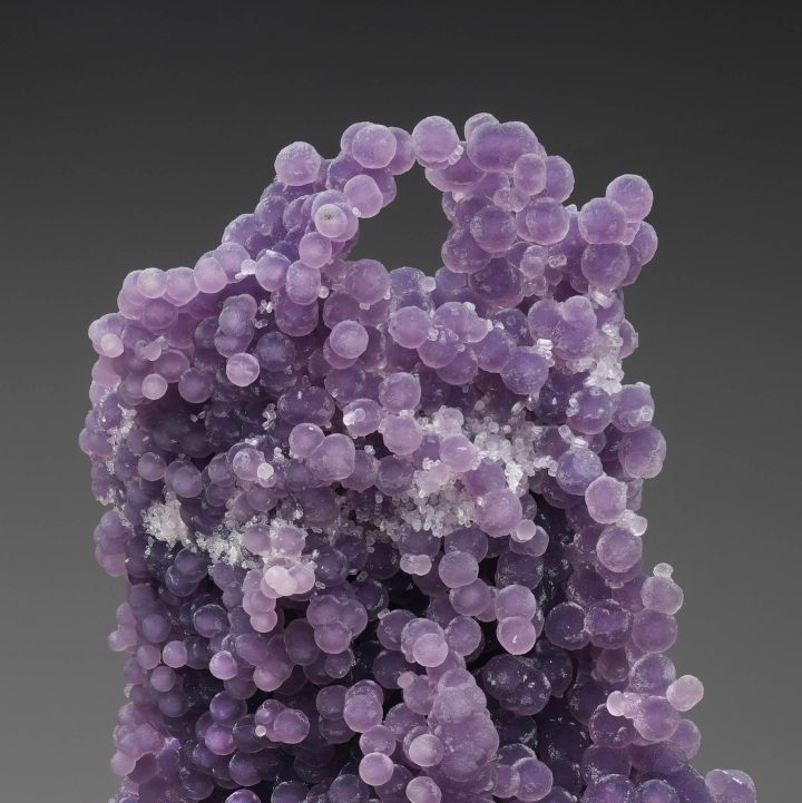 Macro view of grape agate crystal surface, showcasing fine botryoidal texture and purple tones
