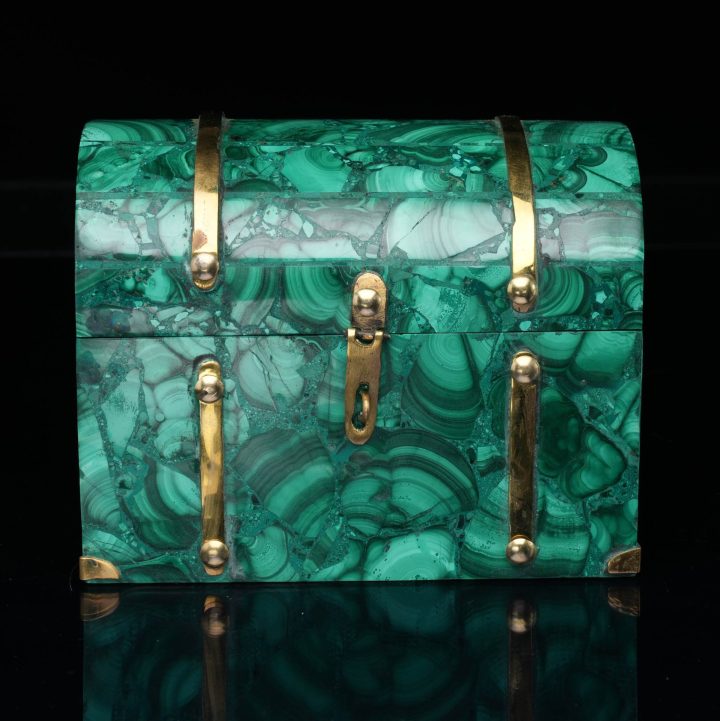 Malachite decorative box showcasing natural green banded patterns with polished stone surface and brass accents