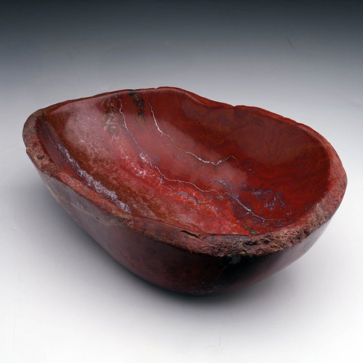 Hand-polished red petrified wood bowl with natural fossil grain and sculptural shape