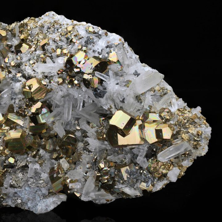 Macro view of pyrite crystals on quartz matrix, emphasizing gold metallic texture and natural crystal growth