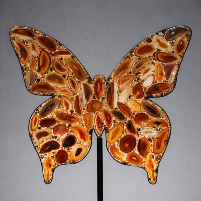 Agate slice butterfly sculpture showcasing natural banded patterns and warm amber tones