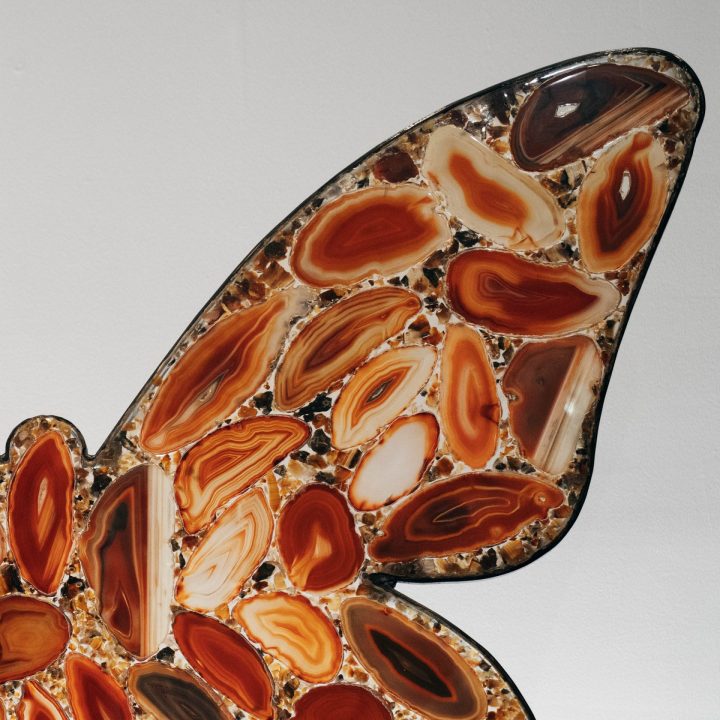 Macro view of agate slices forming a butterfly sculpture, showcasing organic stone texture and polished finish