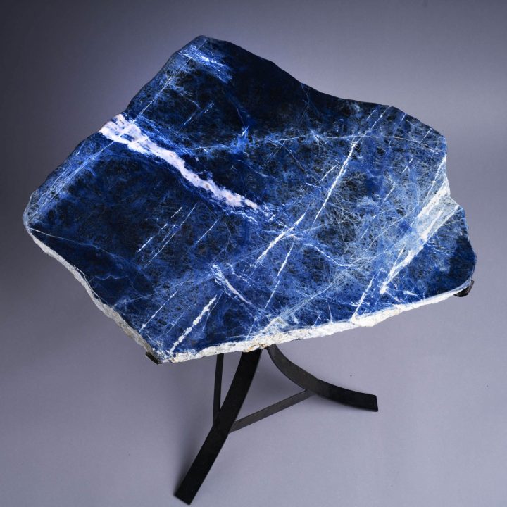 Top view of blue stone slab table showcasing deep blue color and natural white veining