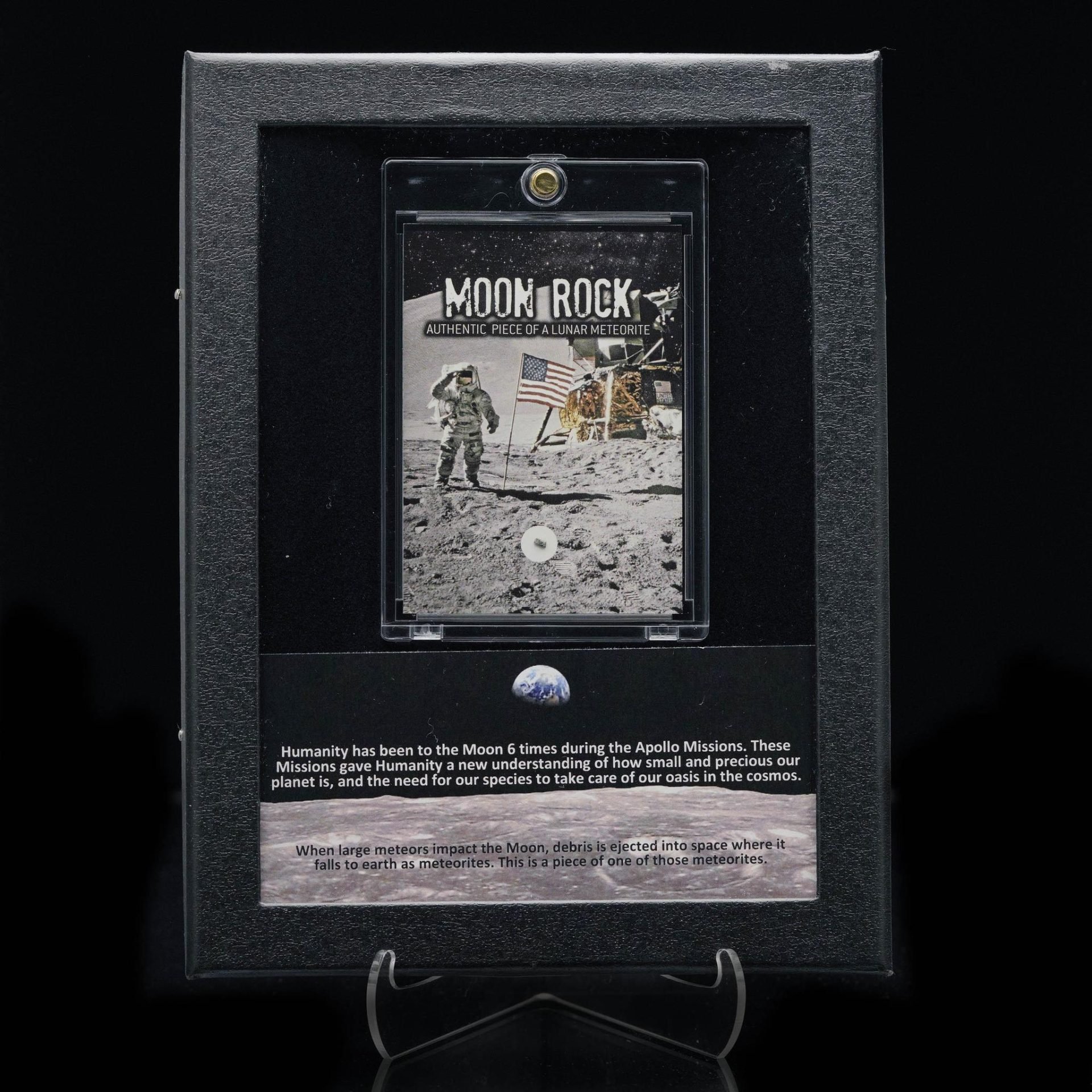 A framed display features an authentic moon rock, Apollo mission imagery, Earth, and descriptive text.